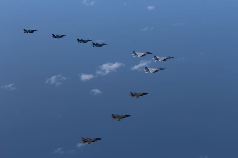 F-15 and F-2 fighters from Japan's Air Self-Defence Force hold a joint military drill with US Marine Aircraft Group's F-35B fighters off Japan's main southern island of Kyushu in this