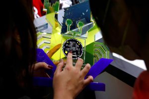  A guide introduces a chip to students on tour at the Science park exploration museum in Hsinchu, Taiwan