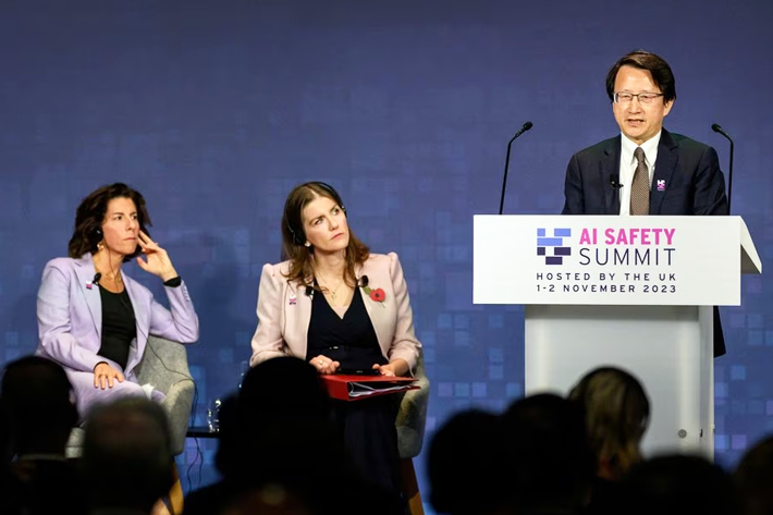 US Secretary of Commerce Gina Raimondo and British Secretary of State for Science, Innovation and Technology Michelle Donelan listen to China's Vice Minister of Science and Technology Wu Zhaohui speaking on Day 1 of the AI Safety Summit at Bletchley Park in Bletchley, Britain