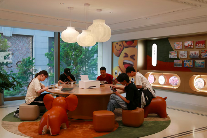 People sit at a children's area inside Huawei's flagship store in Shanghai, China