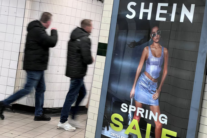 People walk past an advertisement for Shein, in London, Britain